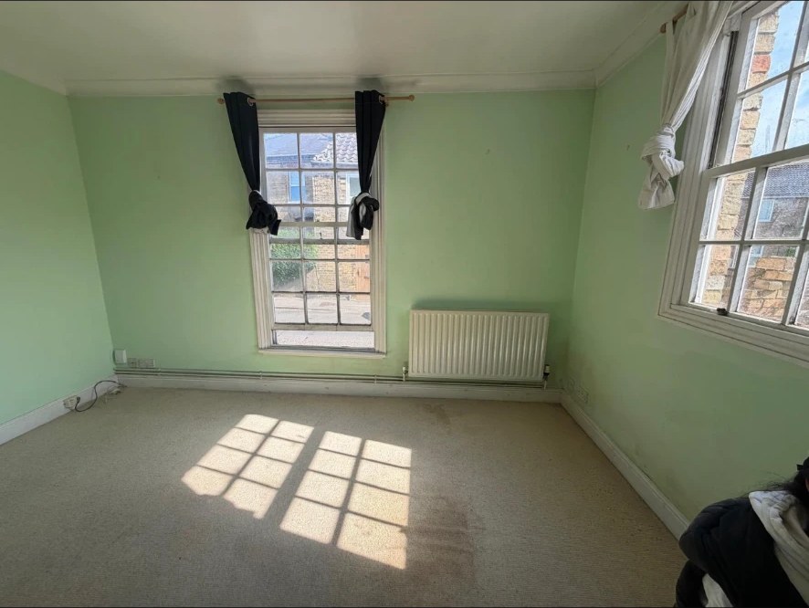Damp-affected bedroom — Tide marks and staining at skirting level — classic signs of rising damp in a period property.
